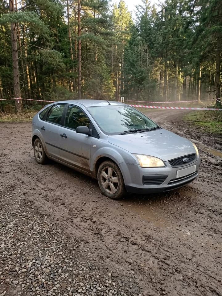 Rally Stage: a car slides sideways through a gravel forest stage toward the camera. concept preview